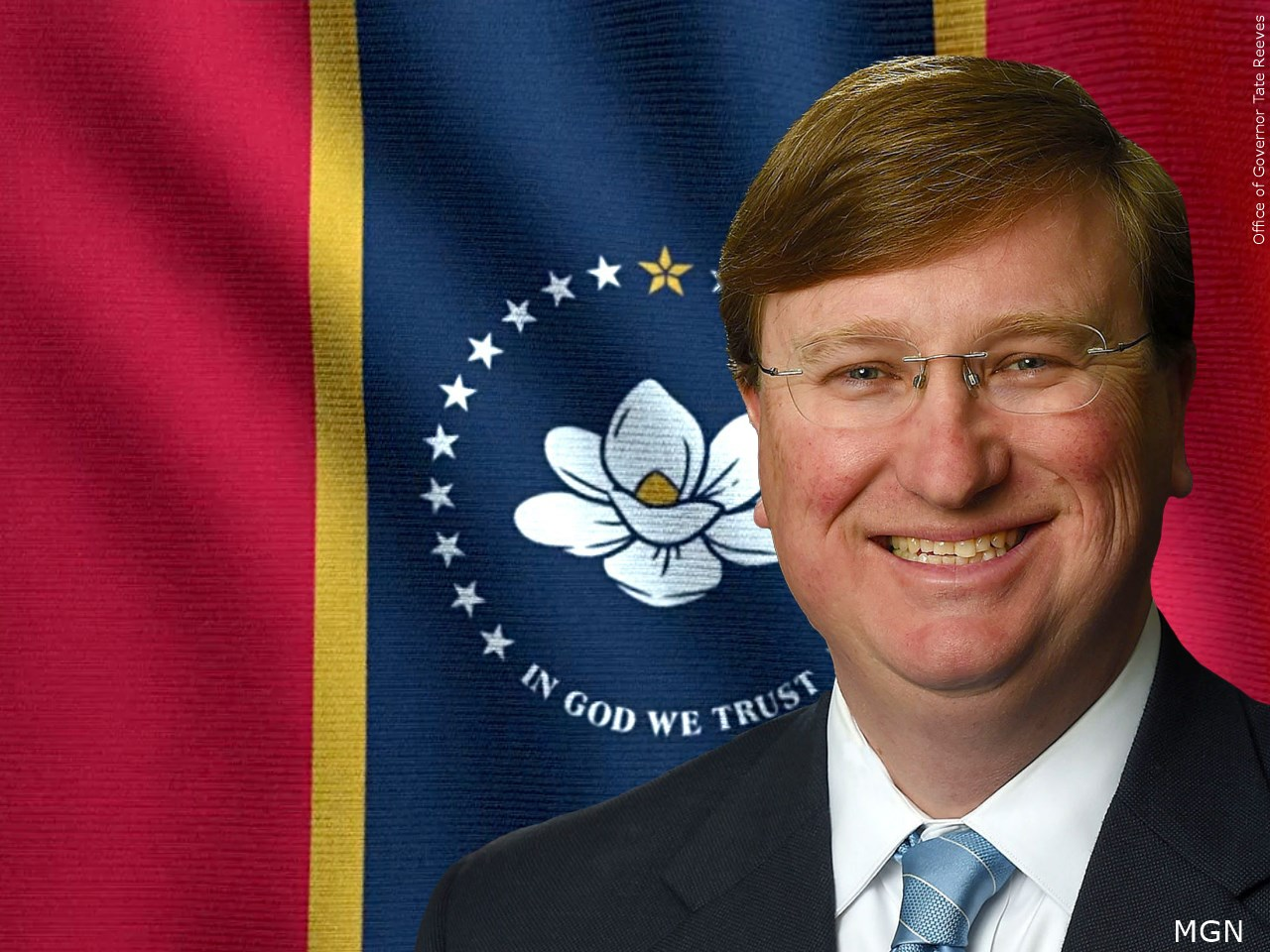 Mississippi Governor Tate Reeves pictured in front of the current Mississippi state flag